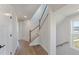 Hallway with wood floors and white walls leads to a stairway with a wood railing and light-filled rooms at 509 Sherron Rd # 22, Durham, NC 27703