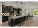 Modern kitchen with a large island, sleek black cabinets, and a dining area at 509 Sherron Rd # 22, Durham, NC 27703