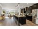 Open kitchen concept with a large island, black cabinetry, and stainless steel appliances at 509 Sherron Rd # 22, Durham, NC 27703