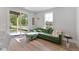Bright living room featuring a green sofa, natural light, and wood floors at 509 Sherron Rd # 22, Durham, NC 27703