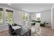A bright office area with large windows, a desk, and a green sofa for relaxing at 509 Sherron Rd # 22, Durham, NC 27703