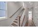 Elegant staircase with hardwood treads, white risers, and natural light pouring in from a window at 509 Sherron Rd # 22, Durham, NC 27703