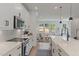 Stylish kitchen boasts white cabinets, modern appliances, and views into the living area at 509 Sherron Rd # 25, Durham, NC 27703