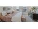 Bright main bedroom features large windows, neutral walls, and a bench at the foot of the bed at 509 Sherron Rd # 25, Durham, NC 27703