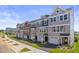 Street view of lovely townhomes with driveways, garages, and attractive landscaping on a sunny day at 509 Sherron Rd # 25, Durham, NC 27703