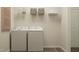 Functional laundry room features washer, dryer, storage shelf, and clean design at 536 Morning Light Dr, Angier, NC 27501