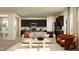 Open-concept living area with dark cabinets, stainless steel appliances, and a dining area at 536 Morning Light Dr, Angier, NC 27501