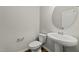 Compact bathroom with a pedestal sink, toilet, and neutral color scheme at 6012 Kayton St, Raleigh, NC 27616