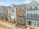 Row of townhouses displaying neat landscaping, varied exteriors, and inviting front entrances at 6012 Kayton St, Raleigh, NC 27616