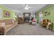 Bright living room with a fireplace, built-in shelves, neutral-toned furniture and green-painted walls at 6480 Union Ridge Rd, Burlington, NC 27217