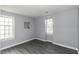 Light-filled bedroom featuring two large windows, gray walls, and vinyl plank flooring at 849 Jeffreys Rd, Rocky Mount, NC 27804