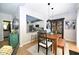 Inviting dining area with a wood table set and bar seating looking into the stylish white kitchen at 8613 Thunderwood Dr, Raleigh, NC 27617