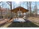 Relaxing backyard gazebo with bench and table and chairs, ideal for outdoor seating and tranquility at 900 Ricon Pl, Durham, NC 27703