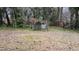 Overgrown backyard with chain link enclosure at 1106 Proctor St, Durham, NC 27707