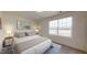 A stylish bedroom featuring neutral tones, ample natural light from the window, and modern furnishings at 1137 Centerview Dr, Nashville, NC 27856