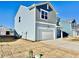 Charming two-story home featuring a two-car garage, light blue siding and a covered front porch at 1137 Centerview Dr, Nashville, NC 27856