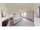 Bright main bedroom featuring neutral colors, carpet flooring, and large windows providing ample natural light at 1137 Centerview Dr, Nashville, NC 27856