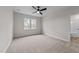 Well lit bedroom with plush carpet, window with view, and ensuite bathroom at 120 Lane Farms Way Way, Holly Springs, NC 27540