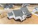 Aerial view of a white home showcasing its gray roof, back patio, and lawn at 120 Lane Farms Way Way, Holly Springs, NC 27540