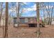 Back of house featuring a deck and a serene view of the surrounding wooded area at 1212 W Pointe, Sanford, NC 27332