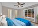 Relaxing bedroom featuring a ceiling fan and abundant natural light from a large window at 1212 W Pointe, Sanford, NC 27332