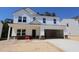 New construction two-story home with a large garage, white siding and brick foundation at 1233 Dimaggio Dr # 7, Raleigh, NC 27616