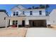 New construction two-story home with a large garage, white siding and brick foundation at 1233 Dimaggio Dr # 7, Raleigh, NC 27616