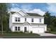 Charming two-story home boasts board and batten siding, a two-car garage, and a well-manicured lawn at 1233 Dimaggio Dr # 7, Raleigh, NC 27616