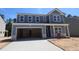 Beautiful two-story home with a large garage and light blue siding at 1240 Dimaggio Dr # 35, Raleigh, NC 27616
