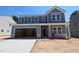 Beautiful two-story home with a large garage and light blue siding at 1240 Dimaggio Dr # 35, Raleigh, NC 27616