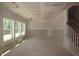 Spacious living room with large windows and a staircase at 1240 Dimaggio Dr # 35, Raleigh, NC 27616