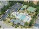 An aerial view of community amenities including a pool, tennis courts, parking, and clubhouse at 132 Mystic Pine Pl, Apex, NC 27539