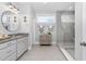 Well-lit bathroom featuring a double vanity, granite countertops, and a stylish tiled shower at 132 Mystic Pine Pl, Apex, NC 27539