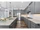 Open kitchen featuring granite countertops, stainless steel appliances, and gray cabinets at 132 Mystic Pine Pl, Apex, NC 27539