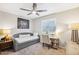 Bedroom features a daybed, desk, ceiling fan, neutral walls, and carpeted floors at 1620 Oakland Hills Way, Raleigh, NC 27604
