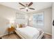 Bedroom with ceiling fan, large window, carpet floors, and neutral colored walls at 1620 Oakland Hills Way, Raleigh, NC 27604