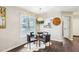 Dining area featuring a modern chandelier and backyard views at 1620 Oakland Hills Way, Raleigh, NC 27604