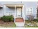 Charming home featuring a cozy front porch with brick steps and manicured landscaping at 1620 Oakland Hills Way, Raleigh, NC 27604