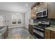 Inviting kitchen with stainless steel appliances, granite countertops, and eat-in dining area at 18 Orangewood Court Ct, Lillington, NC 27546