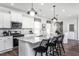 Stylish kitchen with white cabinets, granite counters, stainless appliances, and island seating, perfect for entertaining at 205 Ribbon Rail St, Fuquay Varina, NC 27526