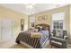 Bright bedroom features a window, accent chair, and a full-sized bed at 217 Old Pros Way, Cary, NC 27513