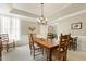 Dining room showcasing a wooden table and chairs, carpet flooring and soft natural light from sheer draped windows at 217 Old Pros Way, Cary, NC 27513