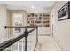 Upstairs hallway features a built-in bookcase and doorway leading to the bedrooms at 217 Old Pros Way, Cary, NC 27513