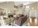 Open-concept living room with a fireplace, tall ceilings, a staircase, and dining area in the background at 217 Old Pros Way, Cary, NC 27513