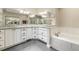 Main bathroom featuring a tub, white cabinets, granite countertops, and ample space at 217 Old Pros Way, Cary, NC 27513