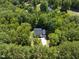 Aerial view of house surrounded by lush trees with private driveway at 2218 Christian Light Rd, Fuquay Varina, NC 27526