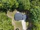 An aerial view of a house with a lush surrounding of trees and a long driveway at 2218 Christian Light Rd, Fuquay Varina, NC 27526