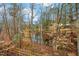 Scenic backyard with a wooden fence and a lush tree canopy at 2218 Christian Light Rd, Fuquay Varina, NC 27526