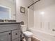 Bright bathroom featuring a granite vanity, modern fixtures, and a shower-tub combo at 2218 Christian Light Rd, Fuquay Varina, NC 27526