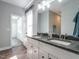 Bathroom with granite countertop, dual sinks, and modern fixtures at 2218 Christian Light Rd, Fuquay Varina, NC 27526